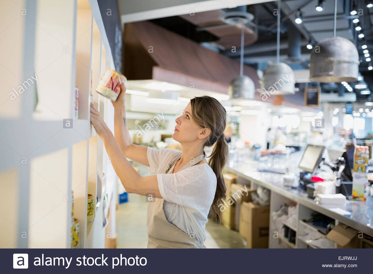 Worker arranging shelves in store Stock Photo Alamy