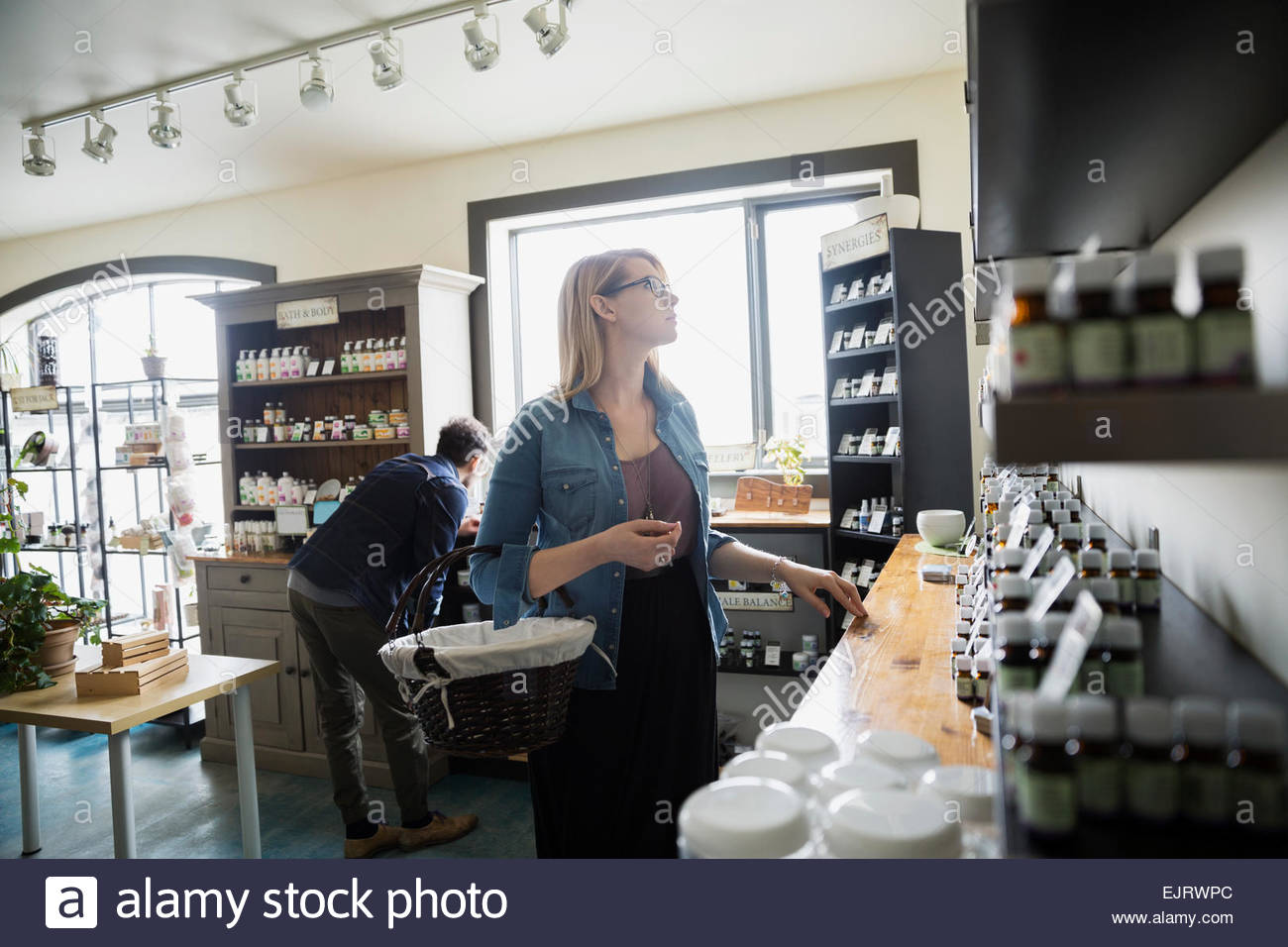 Woman browsing in apothecary shop Stock Photo Alamy