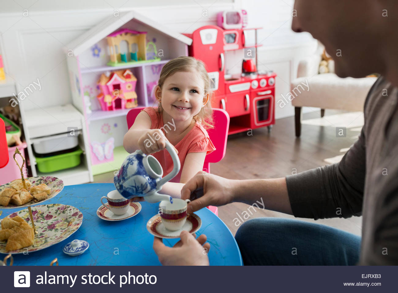 Daughter and father enjoying pretend tea party Stock Photo Alamy