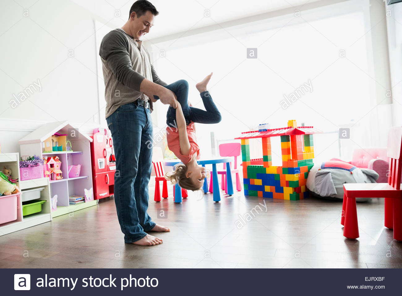 Father flipping daughter upsidedown Stock Photo Alamy