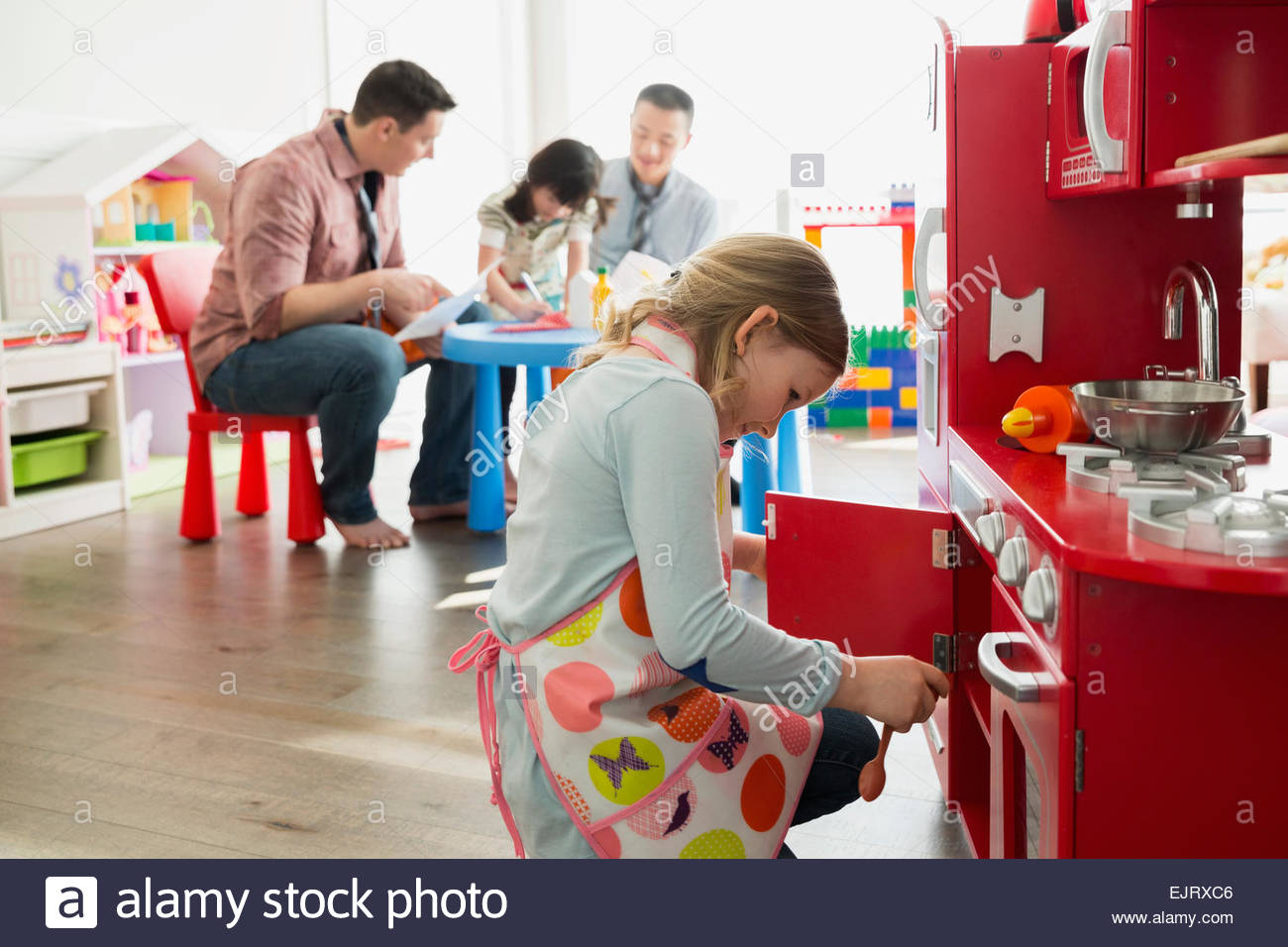 Fathers and daughters playing pretend restaurant Stock Photo