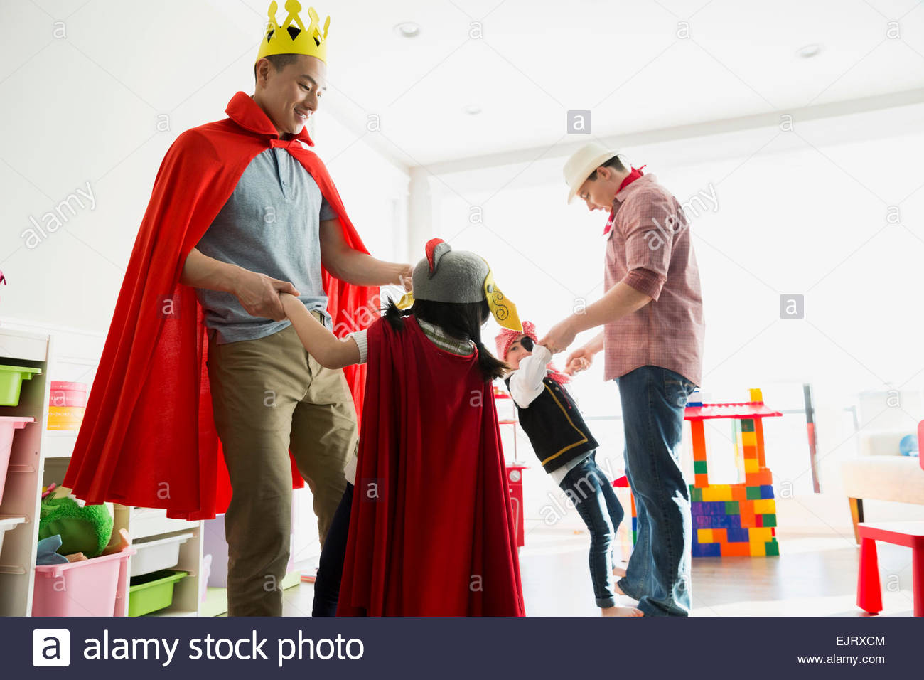 Fathers and daughters in costumes dancing Stock Photo