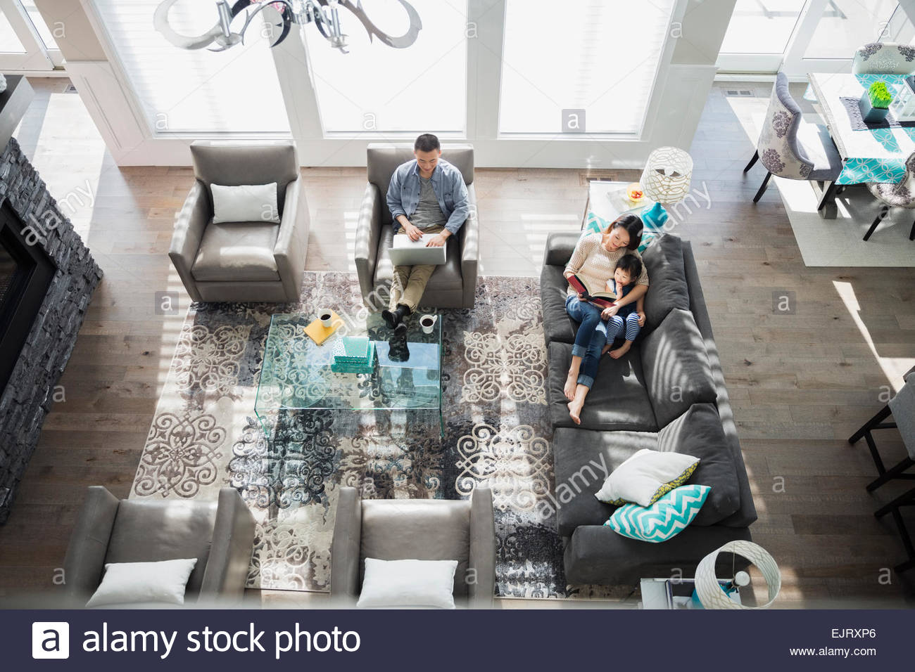 Overhead of family relaxing in living room Stock Photo