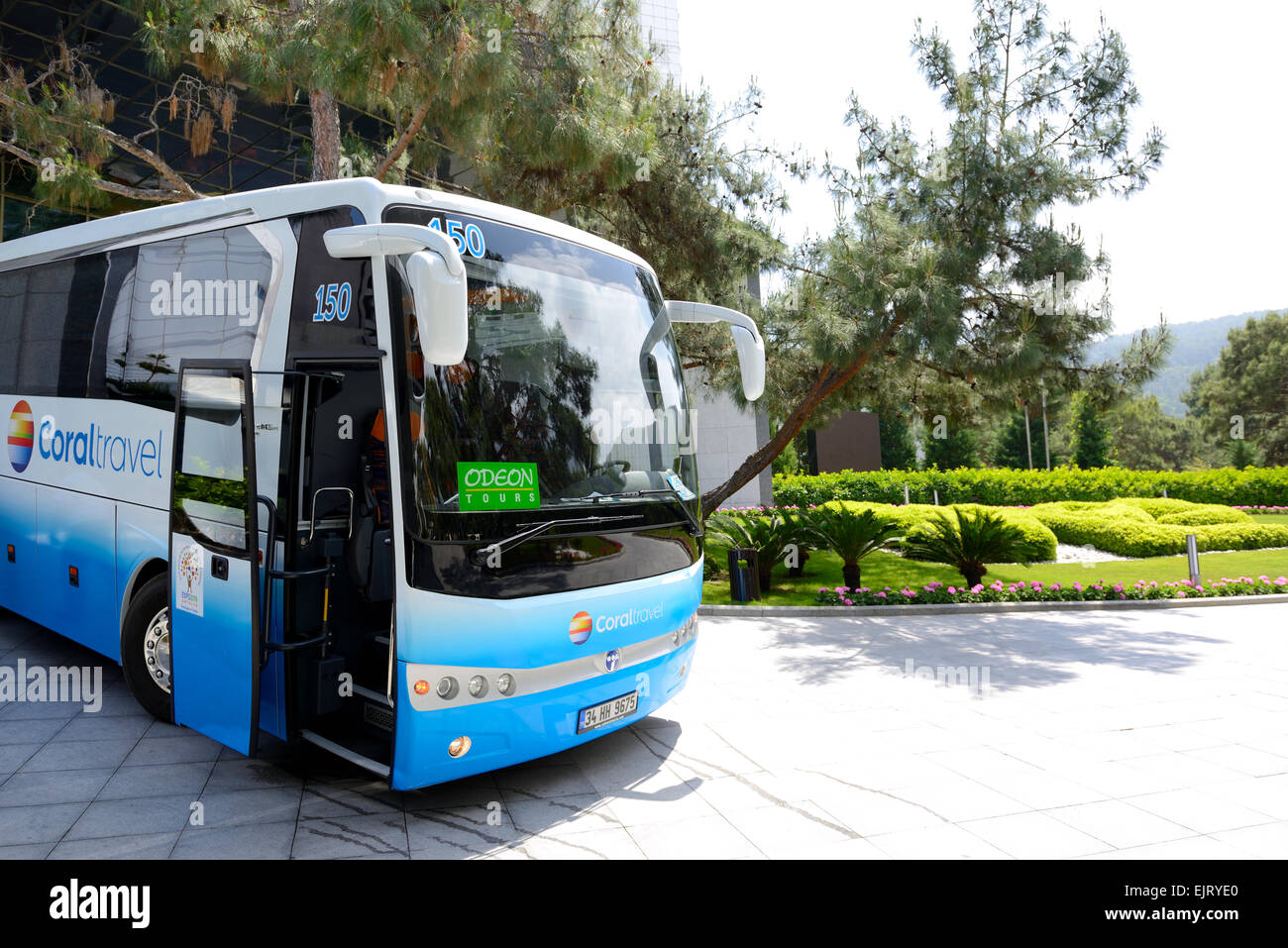 The modern bus for tourists transportation is near entrance to hotel, Antalya, Turkey Stock Photo