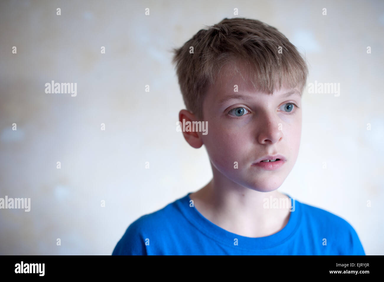 Young Poor White Boy With Short Hair Looking Away From The Camera
