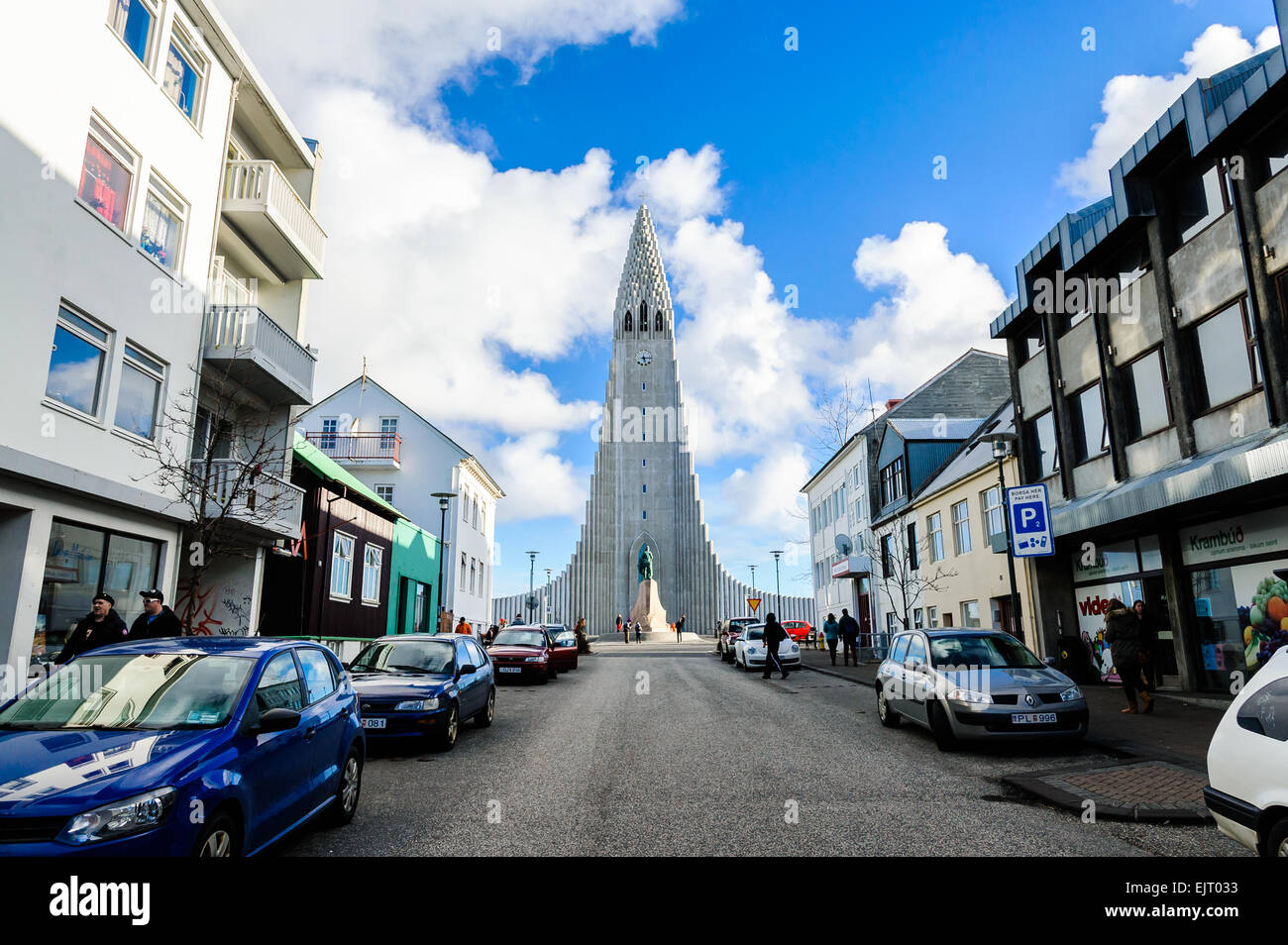 Hallgrímskirkja is seen at the end of a narrow street in Reykjavik, Iceland Stock Photo