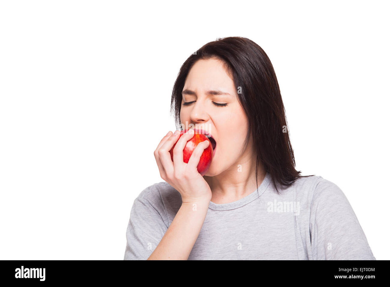 Young woman eating an apple isolated on white Stock Photo