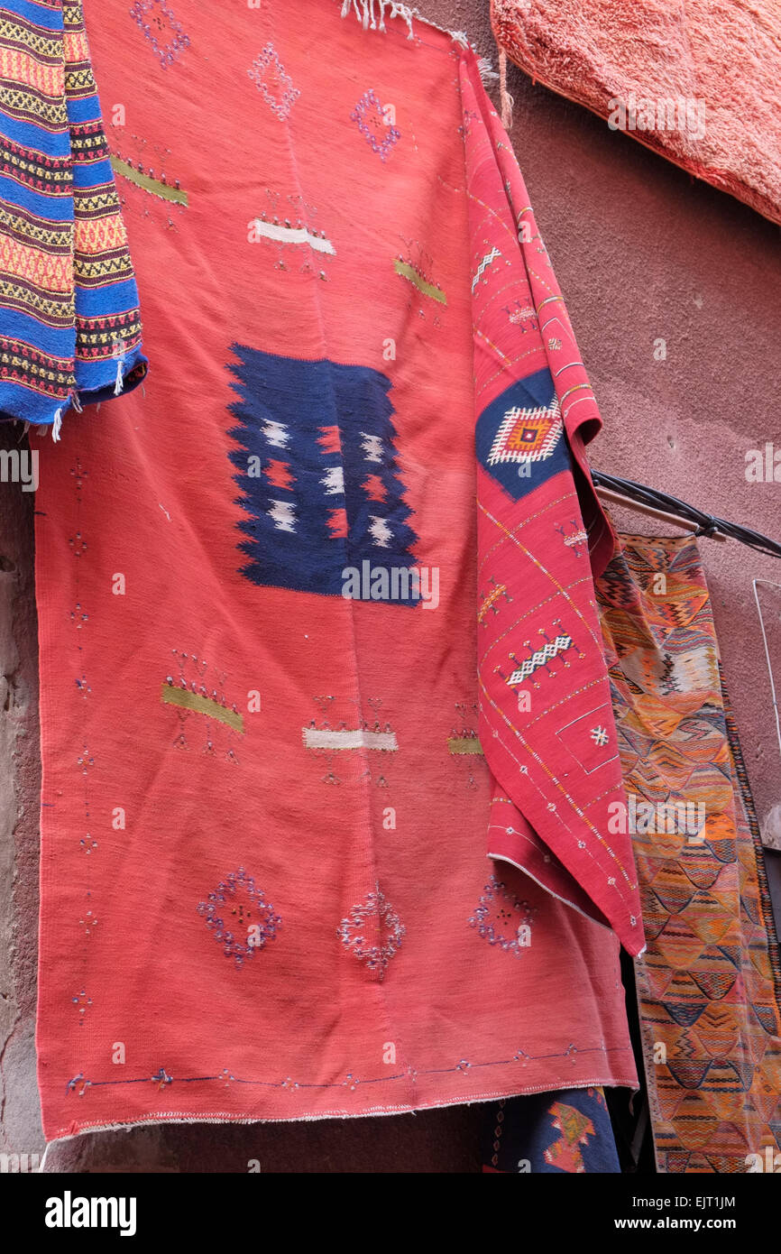 A Moroccan kilim rug on display outside a carpet shop in the Marrakech medina, Morocco, North
