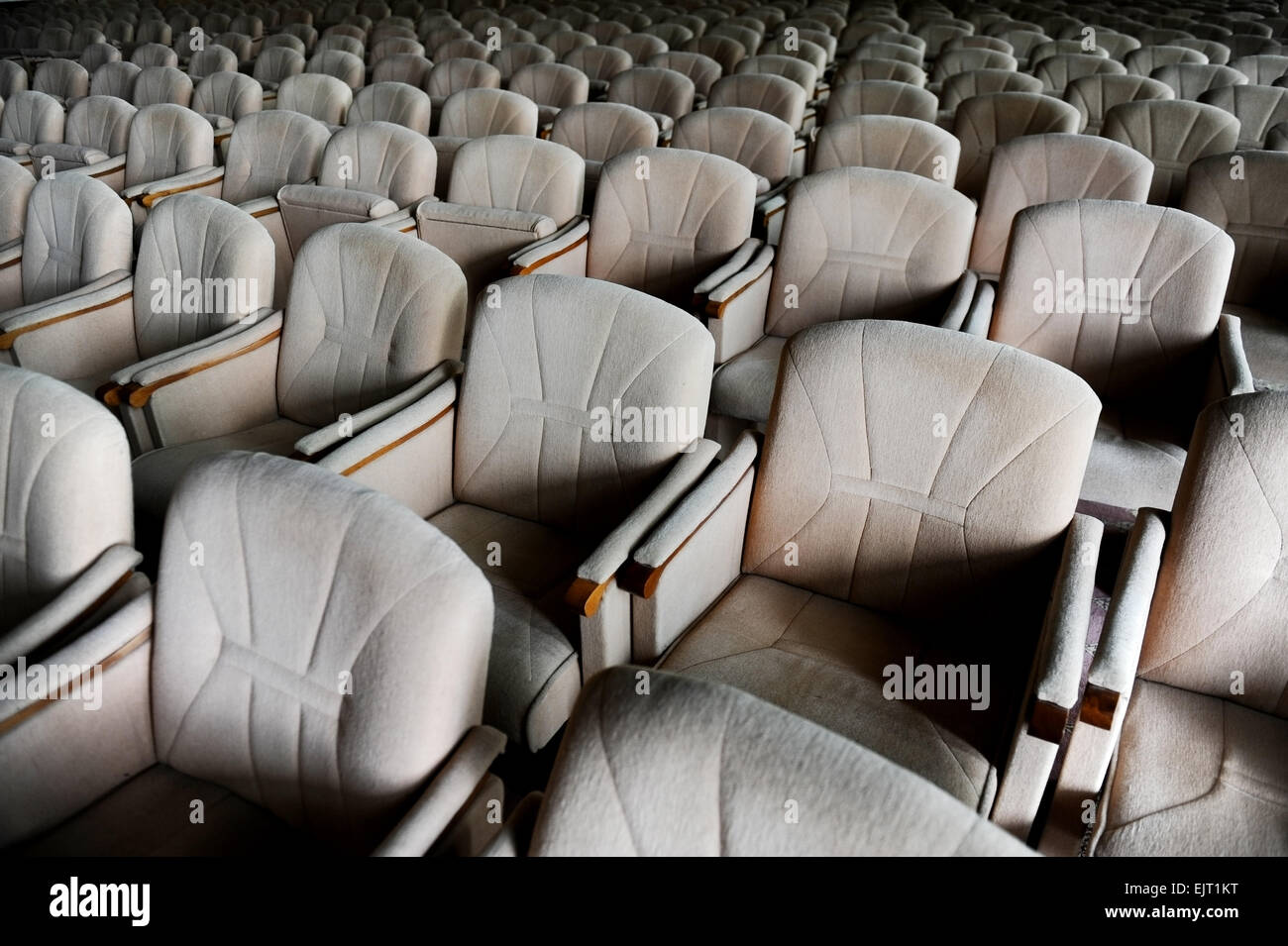 Rows with lots of empty beige velvet armchairs in a big conference room Stock Photo