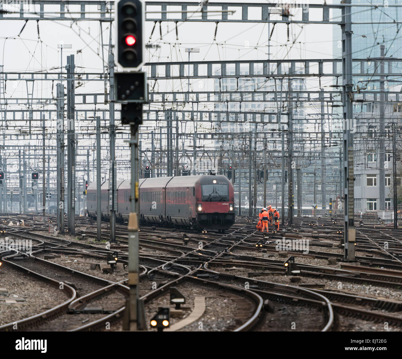 Railway workers and a train on the railway track field of Zurich main station, one of Europe's busiest railway stations. Stock Photo