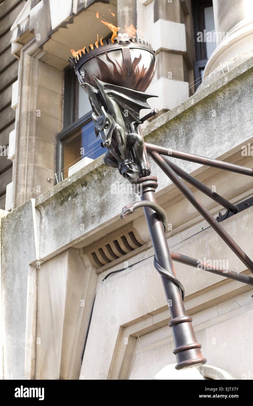 Flaming Torch attached to a building in London england Stock Photo Alamy