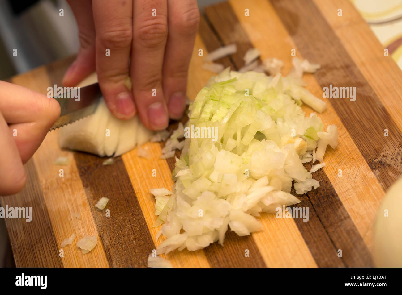 Cook is chopping onion, closeup shoot Stock Photo