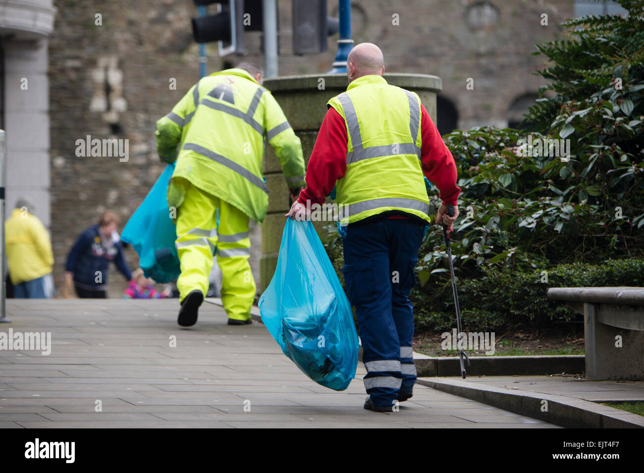Litter pickers Two men working collecting trash rubbish on the street