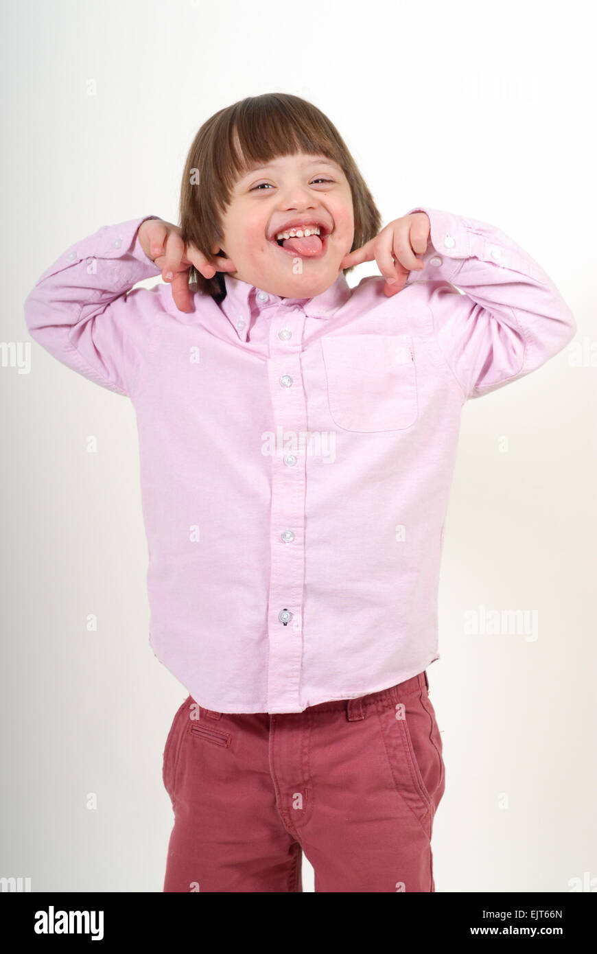 Boy with down syndrome being silly, isolated on white background. Stock Photo
