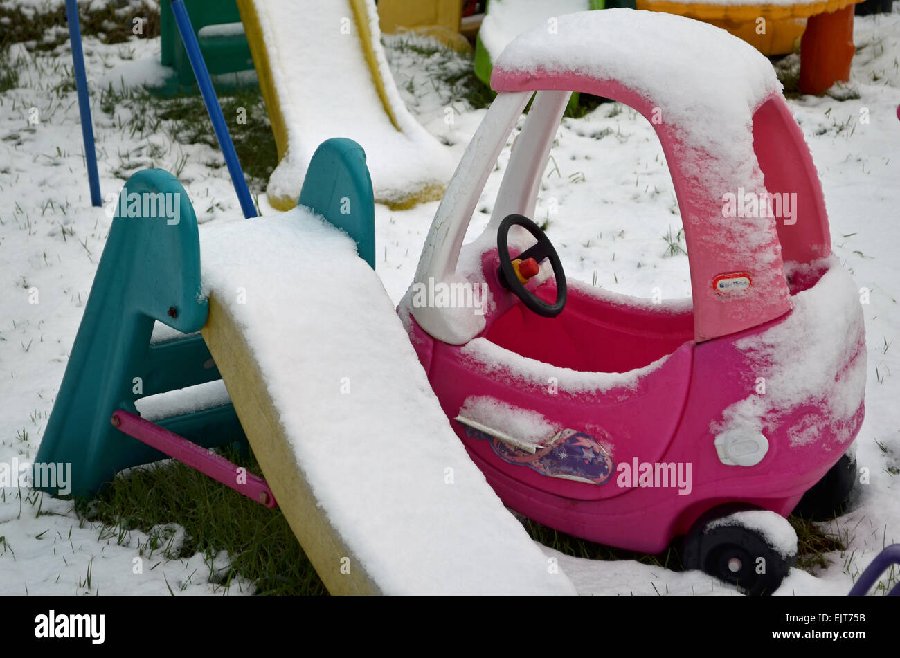 Toy car and slides in the garden covered in snow Stock Photo Alamy