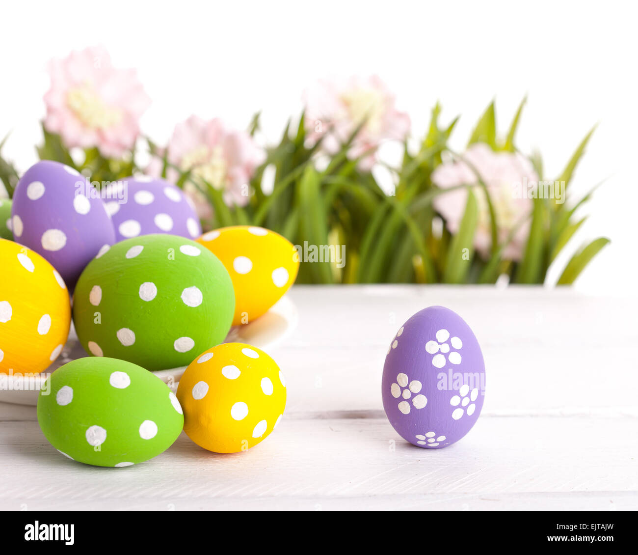 Easter colored eggs on the green grass. Stock Photo
