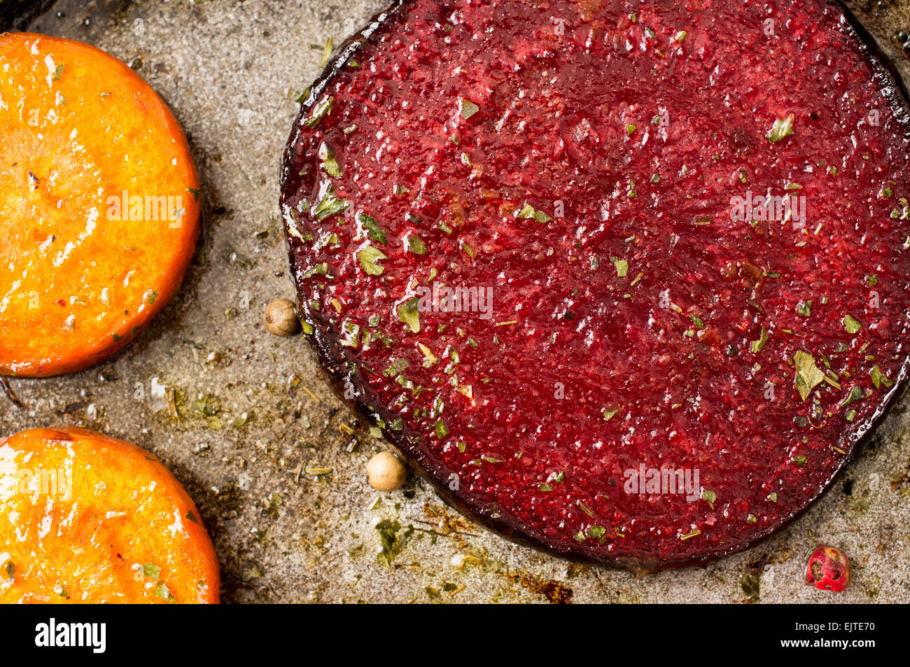 Slice roast beetroot with slices of carrots. Closeup pan on top Stock Photo