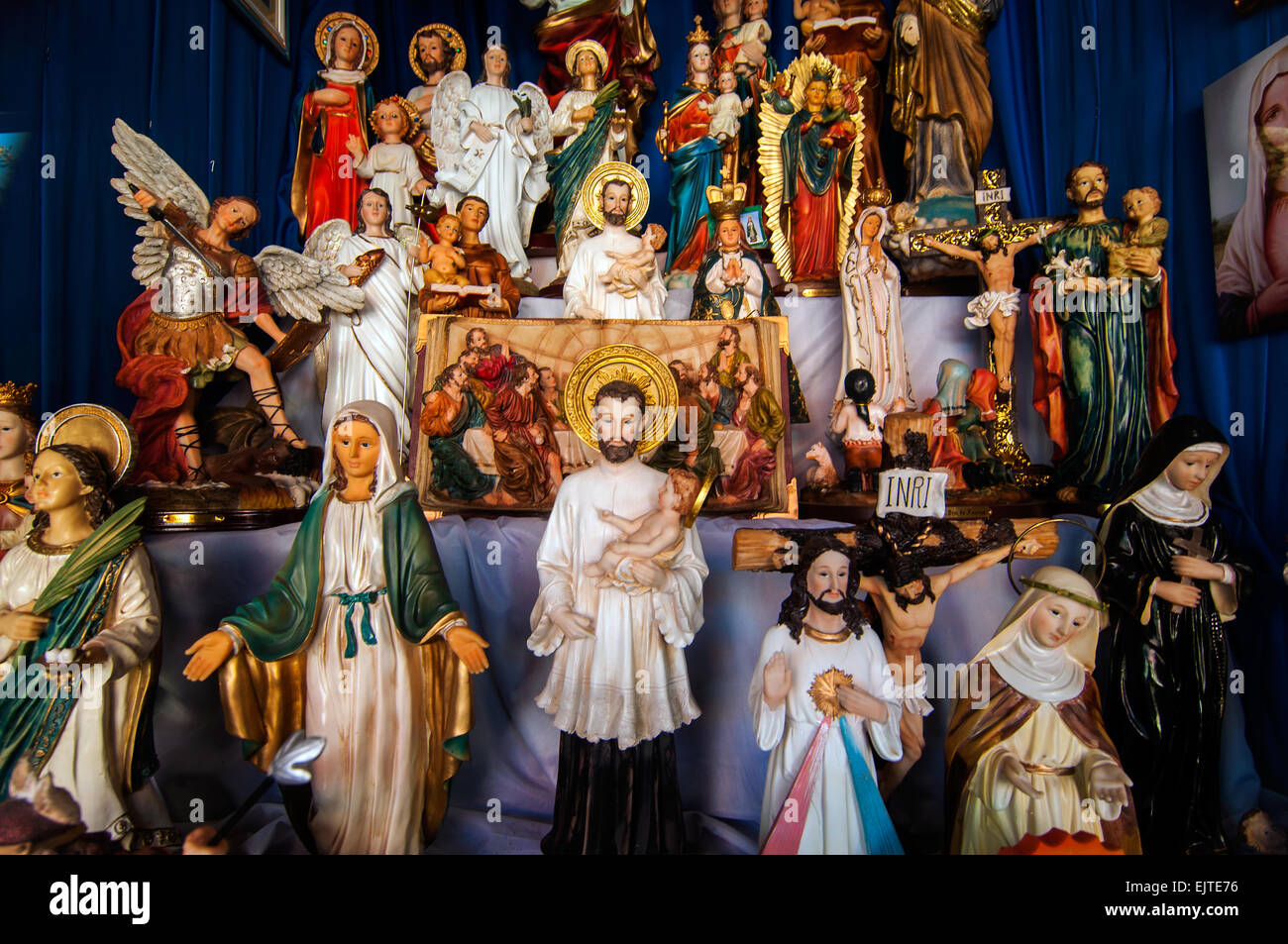 Display of religious icons in shop window, Calle Estigarribia, Encarnacion, Paraguay Stock Photo