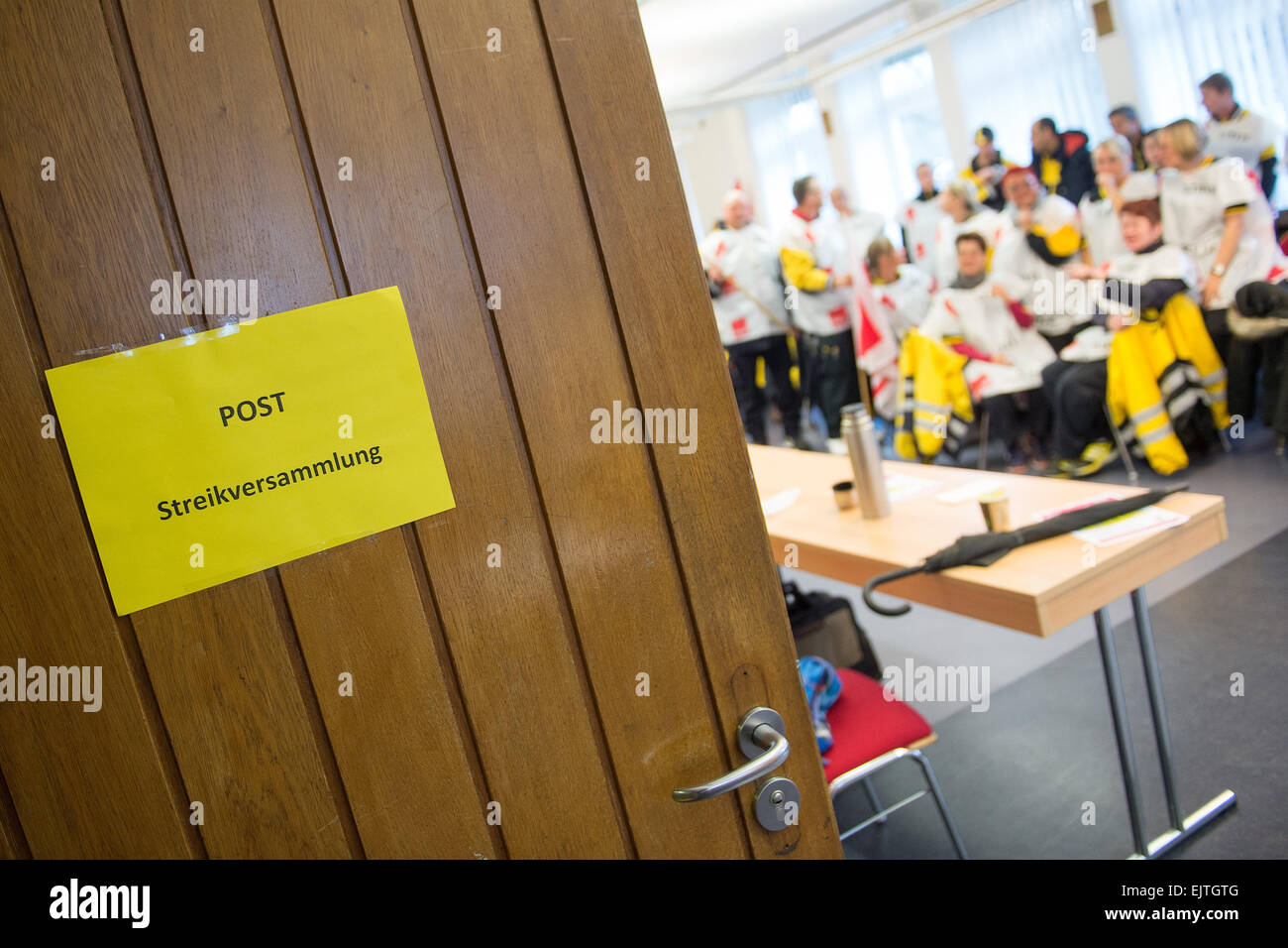 Cologne, Germany. 01st Apr, 2015. Employees with the Deutsche Post (German Postal Service) sit during a strike assembly in Cologne, Germany, 01 April 2015. Employees at many Deutsche Post branches across the country have been on strike since the early shift. Photo: MARIUS BECKER/dpa/Alamy Live News Stock Photo
