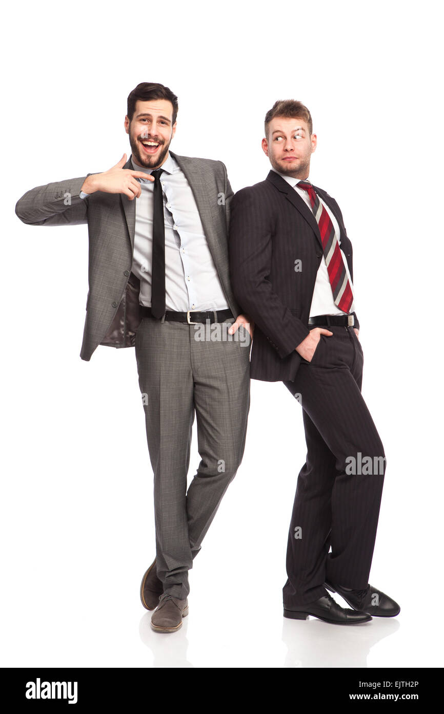 elegant man leans imaginary on one side and pointing his collegue on white Stock Photo
