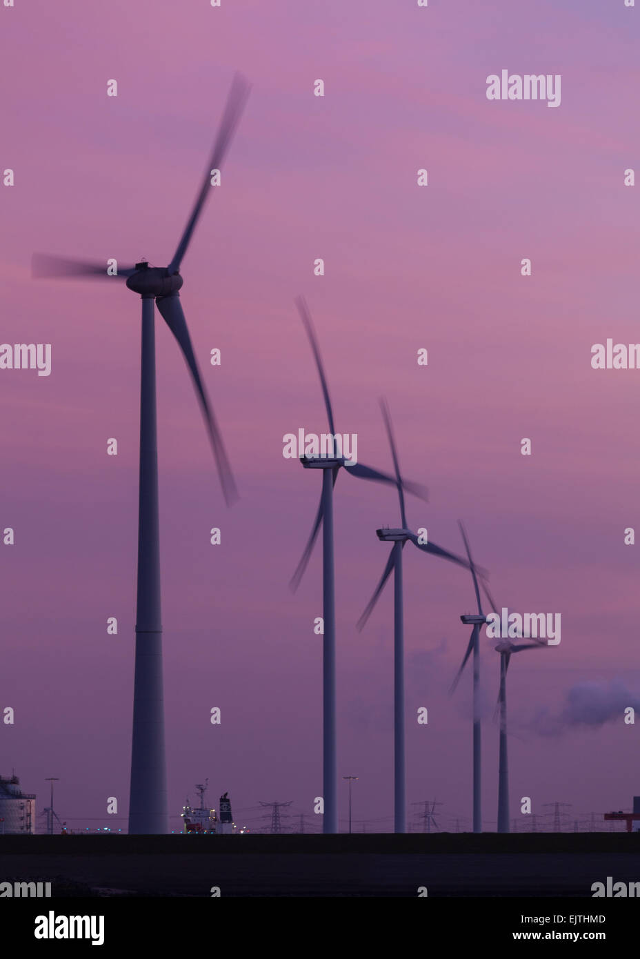 Wind turbines turning at dusk in Eemshaven, Netherlands Stock Photo