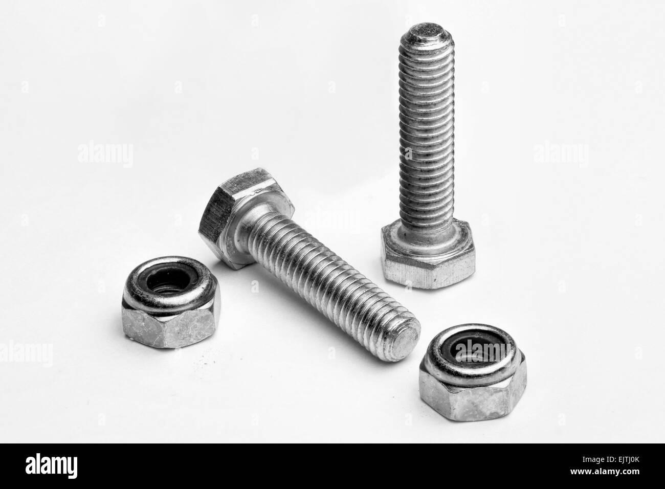 two new locking nuts and bolts isolated on a white background Stock Photo