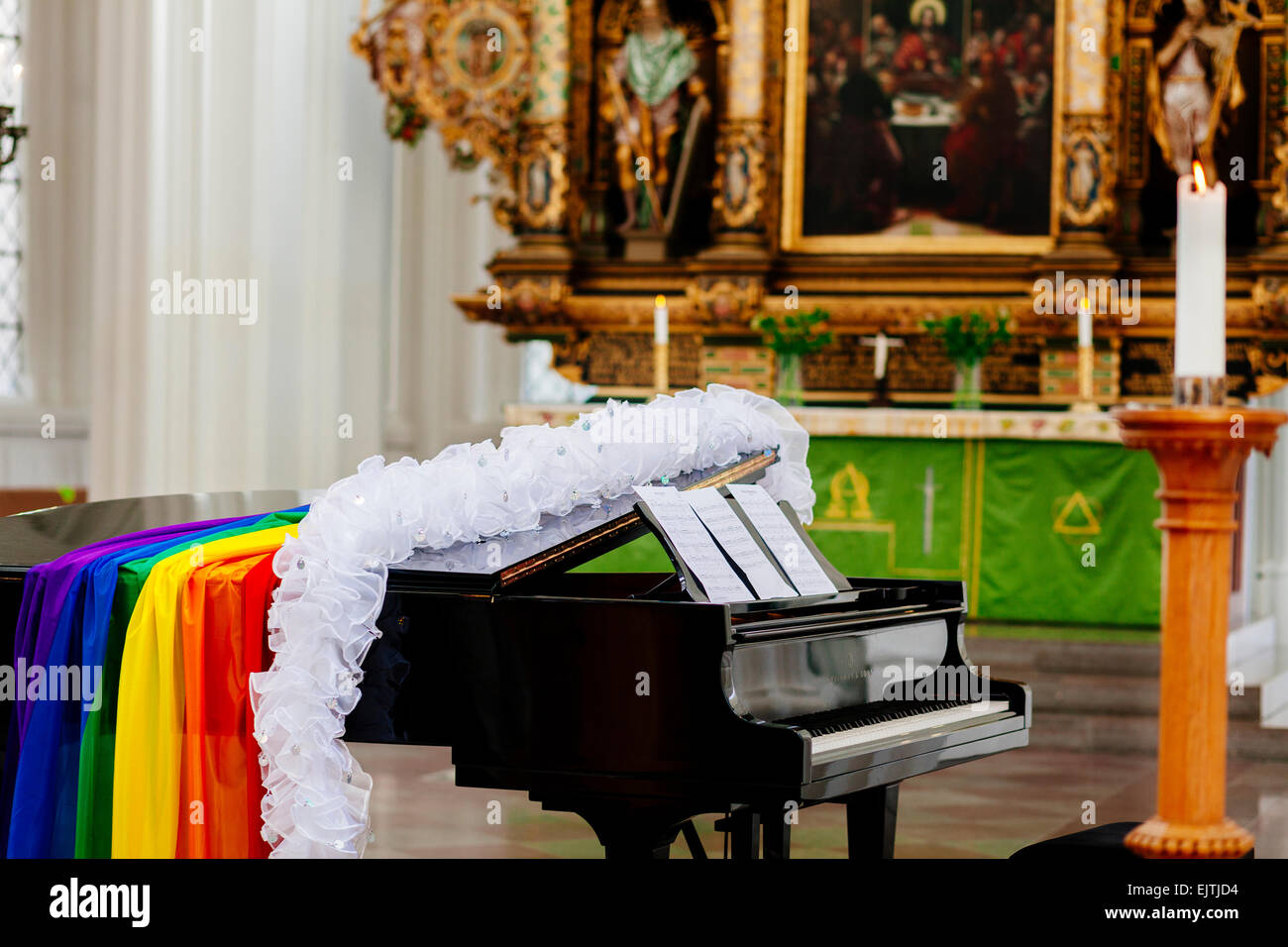 Boa and gay pride flag on grand piano in church Stock Photo - Alamy