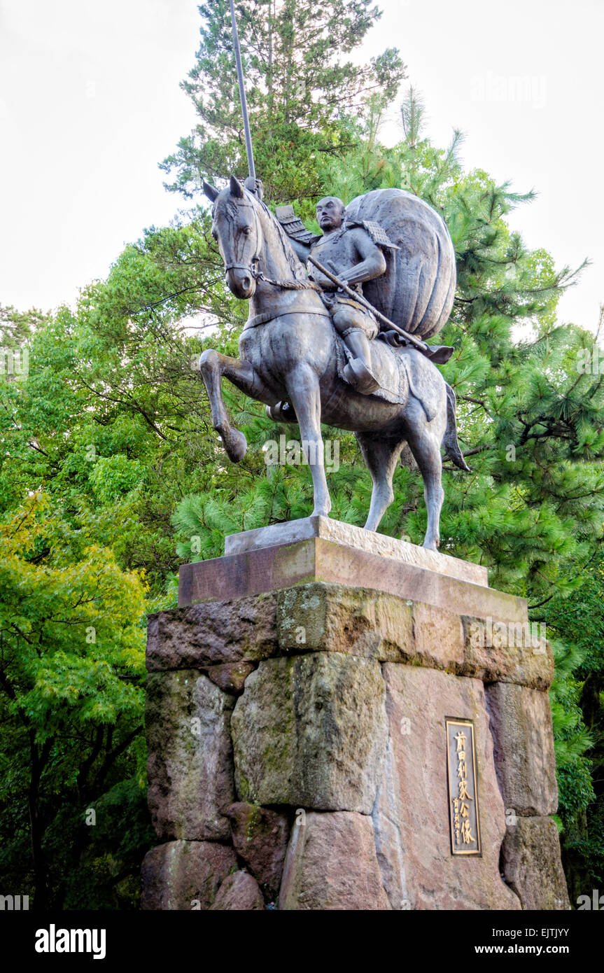 Statue of a samurai lord, wearing armour, on horseback. Japan; Japanese daimyo (provincial ruler); historical figure; daimyo statue; horse rider Stock Photo