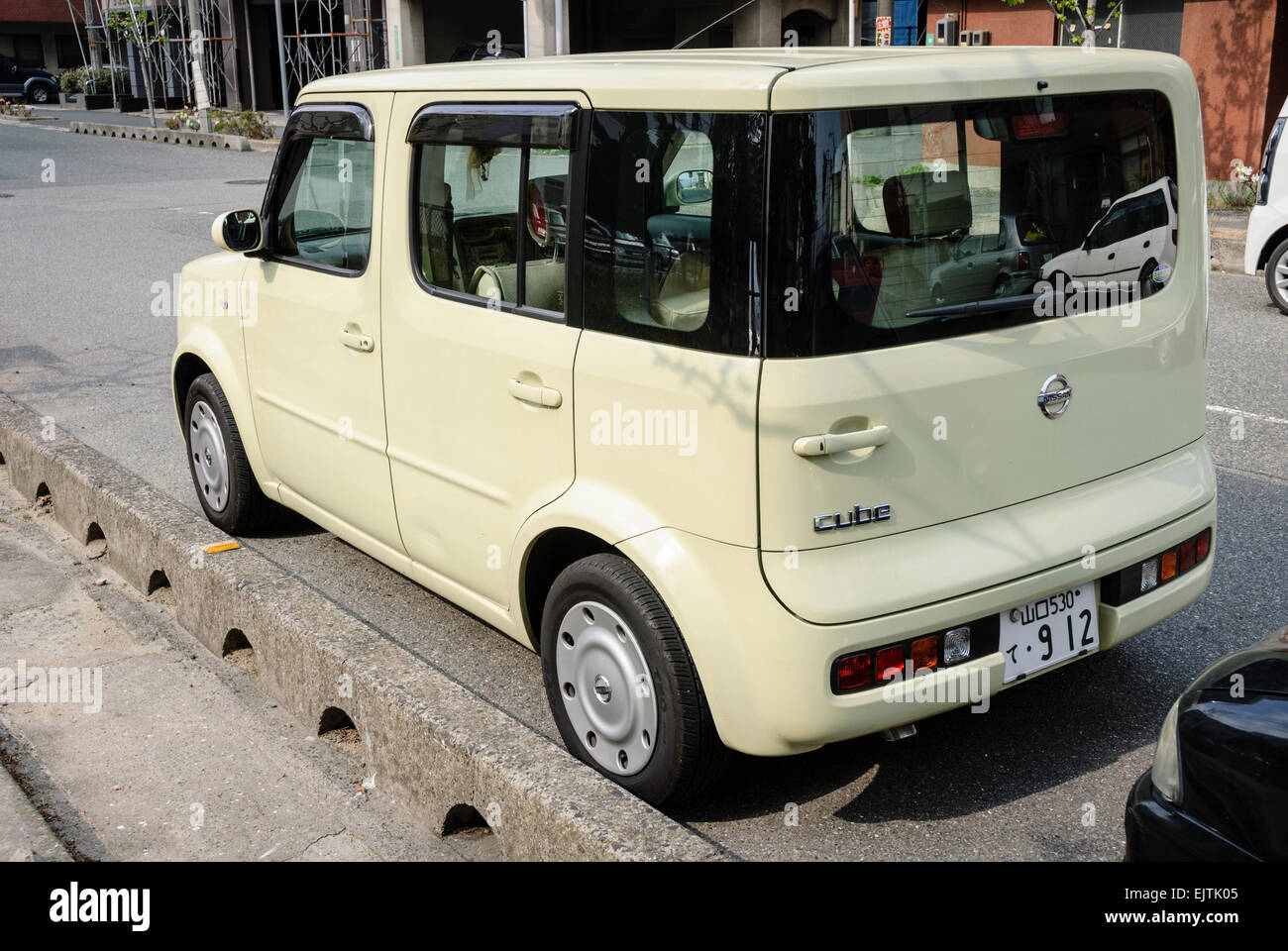 Interesting cuboid car; small Japanese car parked on the street. Stock Photo