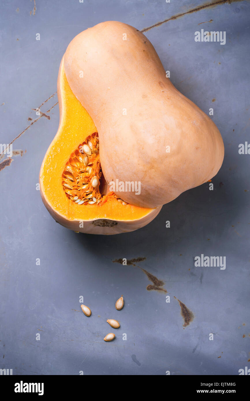 Cut butternut squash over blue metal background. Top view. Stock Photo