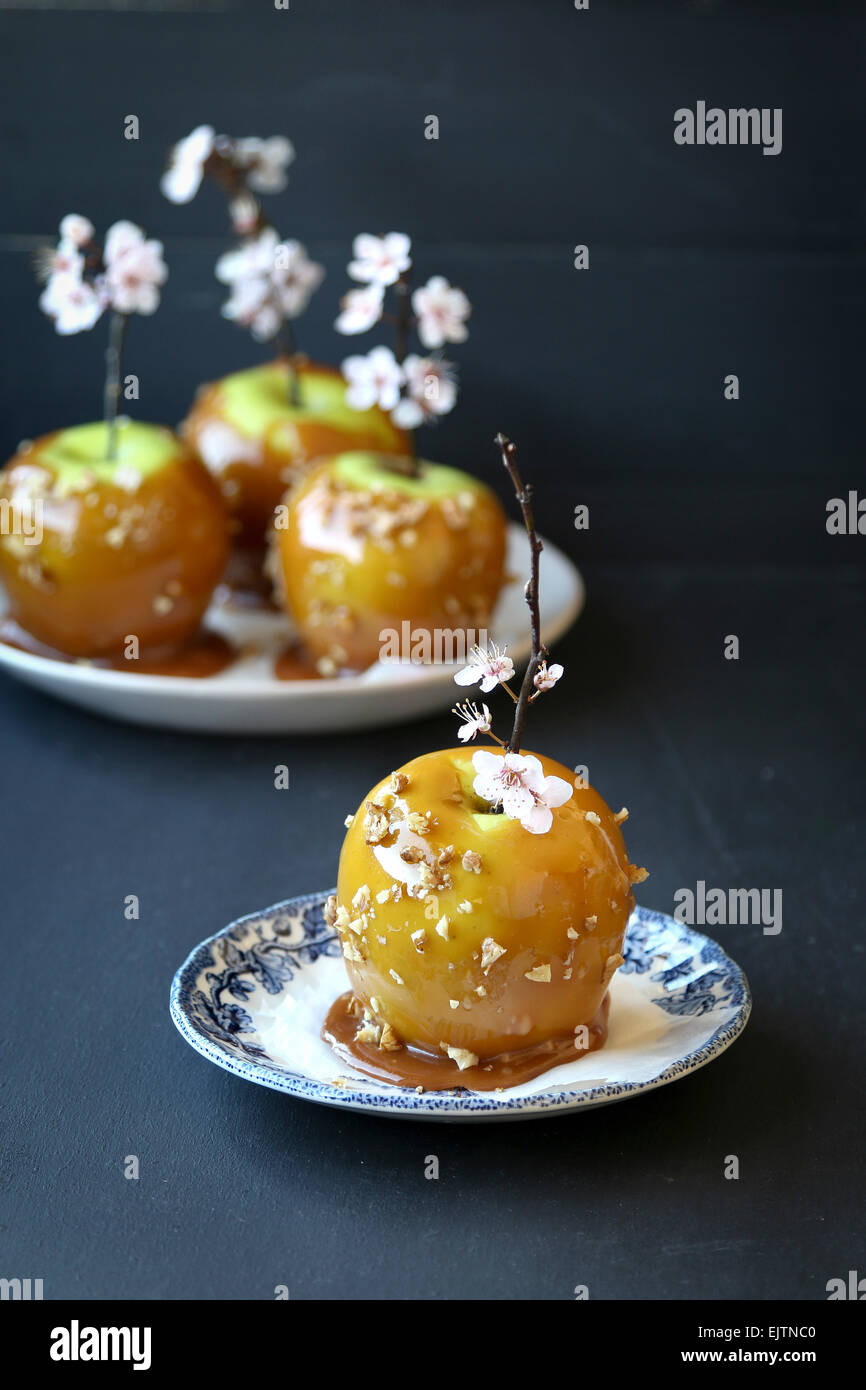 Caramel toffee apples with walnuts on wooden stick Stock Photo Alamy