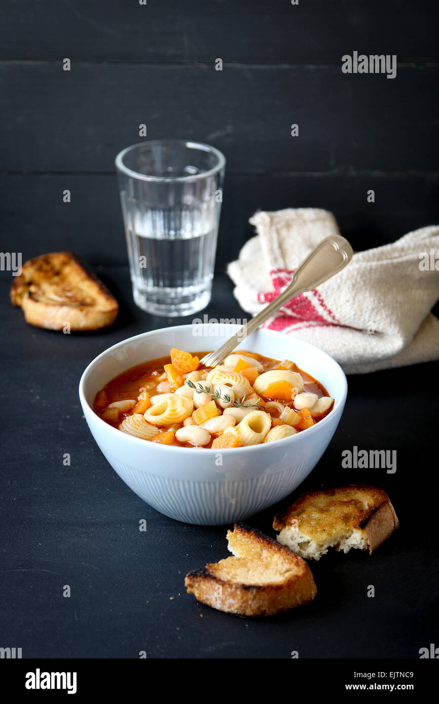 Bowl of Minestrone Soup with Pasta, Beans and Vegetables Stock Photo