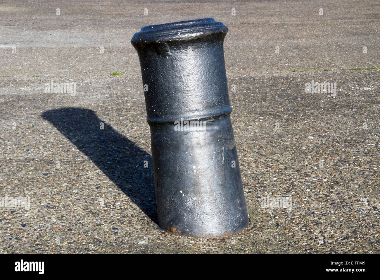 Naval cannon upended and used as bollard, old docks, East India Dock Basin, London Stock Photo