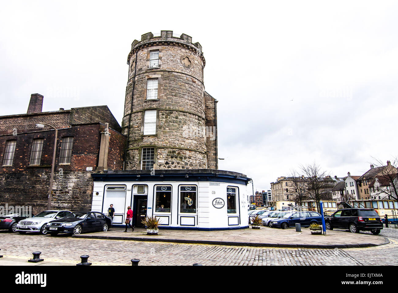 Restaurant built around an old tower sits directly across from a canal in the waterside suburb of Leith in Edinburgh, Scotland. Stock Photo