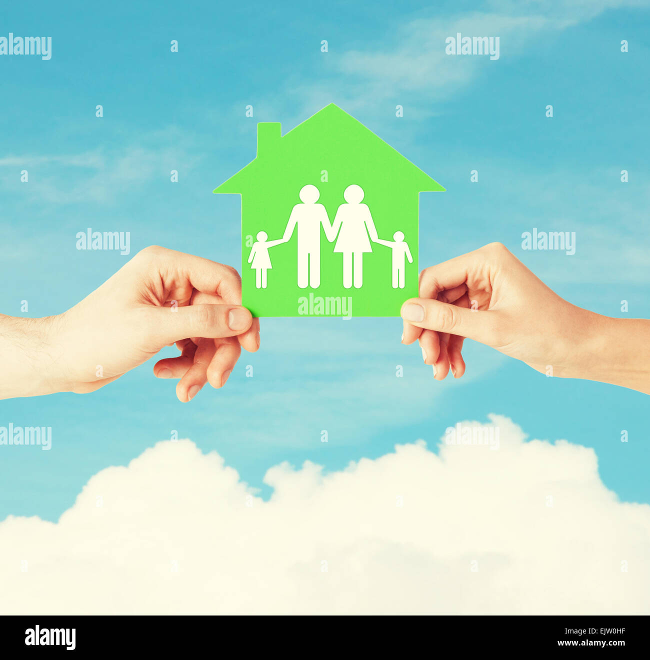 hands holding green house with family Stock Photo - Alamy