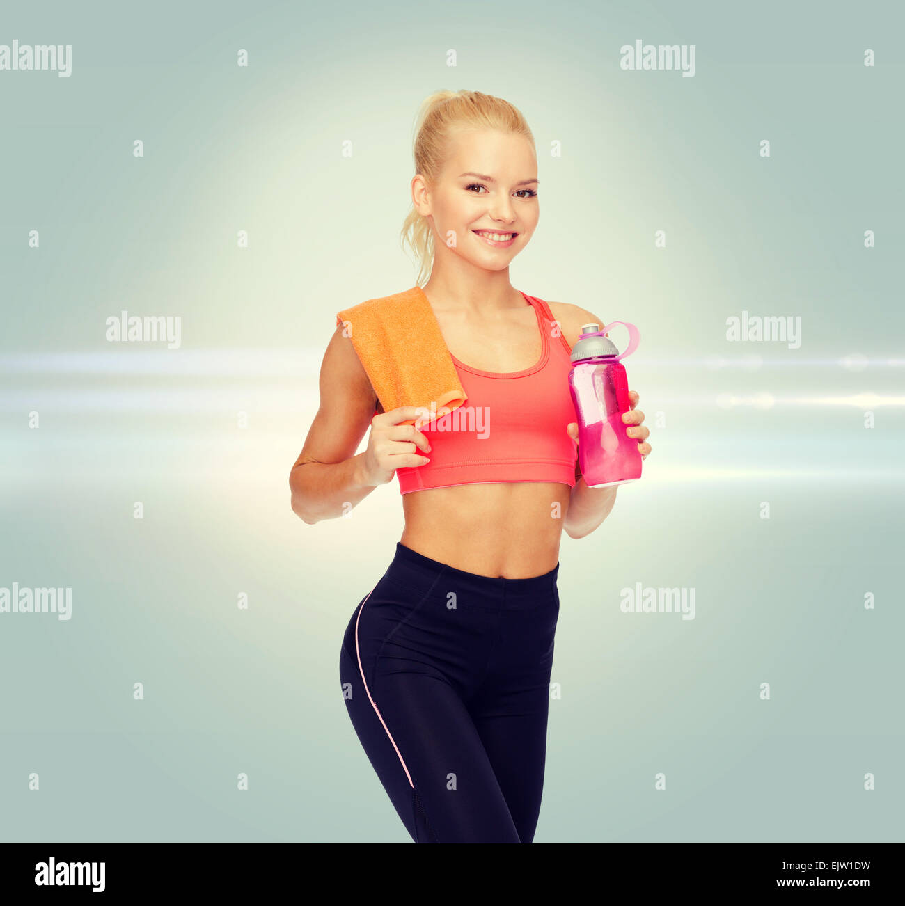 smiling sporty woman with water bottle and towel Stock Photo - Alamy