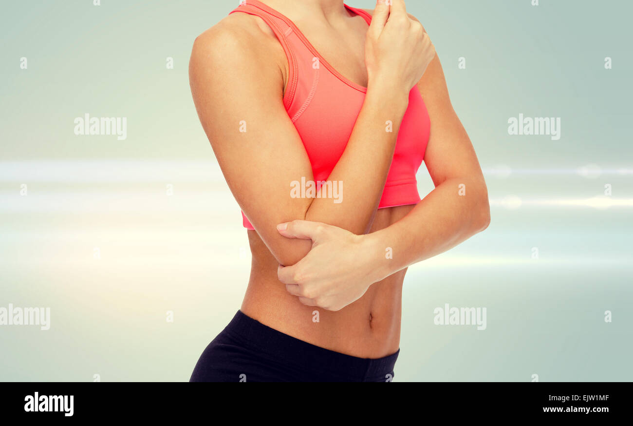 sporty woman with pain in elbow Stock Photo