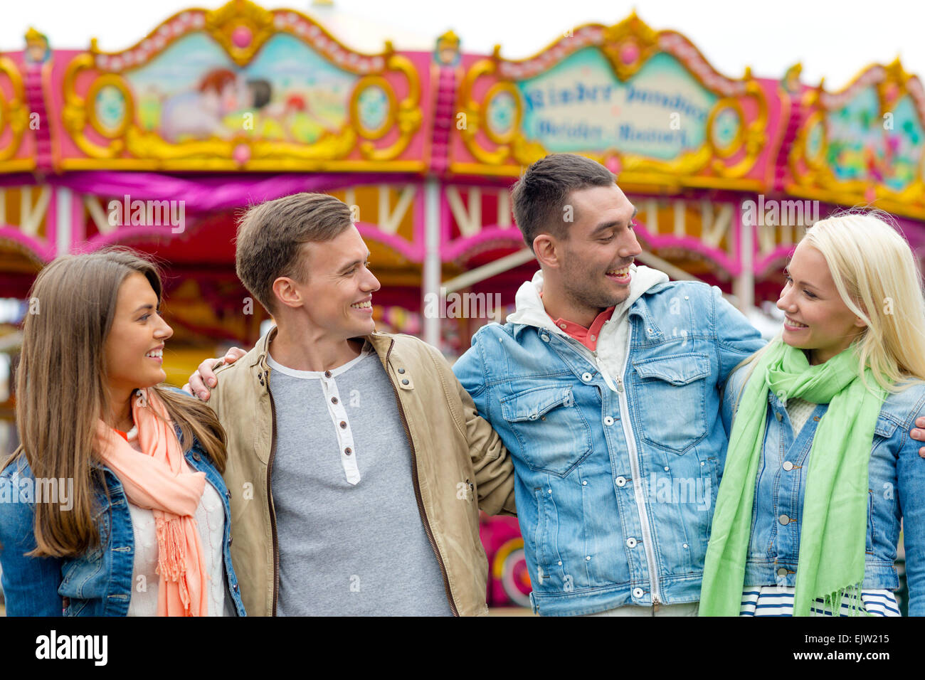 group of smiling friends in amusement park Stock Photo - Alamy