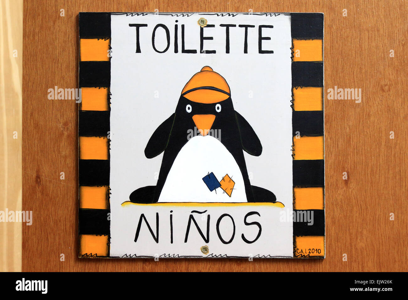 Bathroom sign, toilet sign,  restroom sign on door. Funny sign on toilet door of penguin. Stock Photo