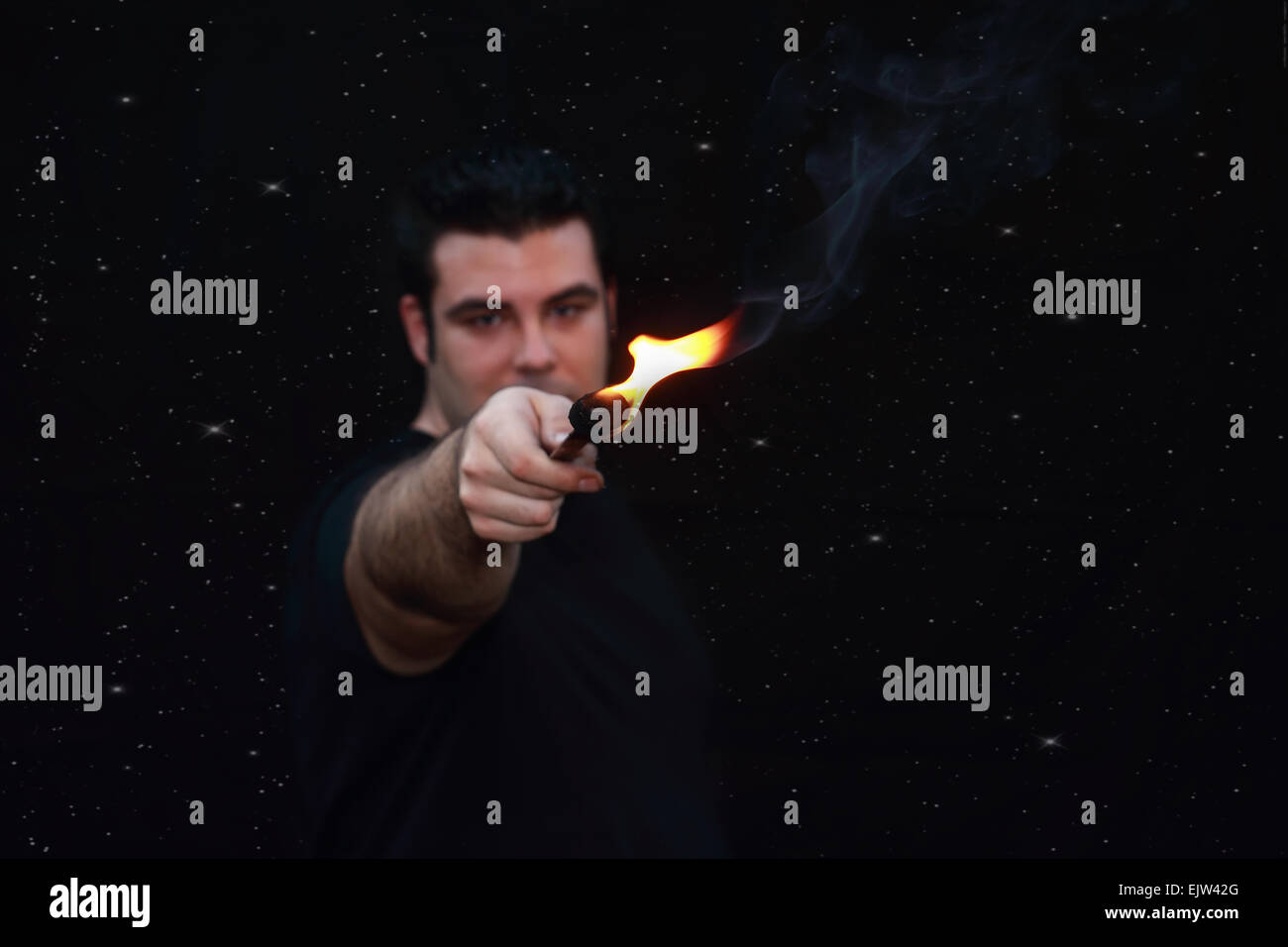 out of focus  fire eater over a starry night background Stock Photo