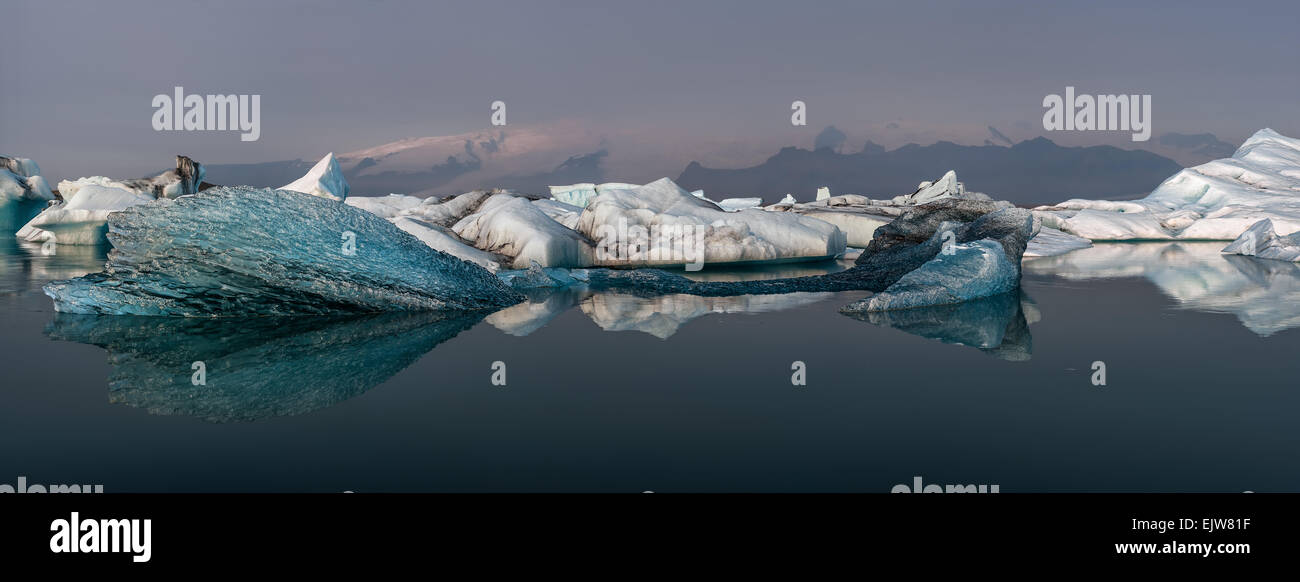 Panorama of Jökulsárlón glacier lagoon with floating icebergs reflected in water, Iceland Stock Photo