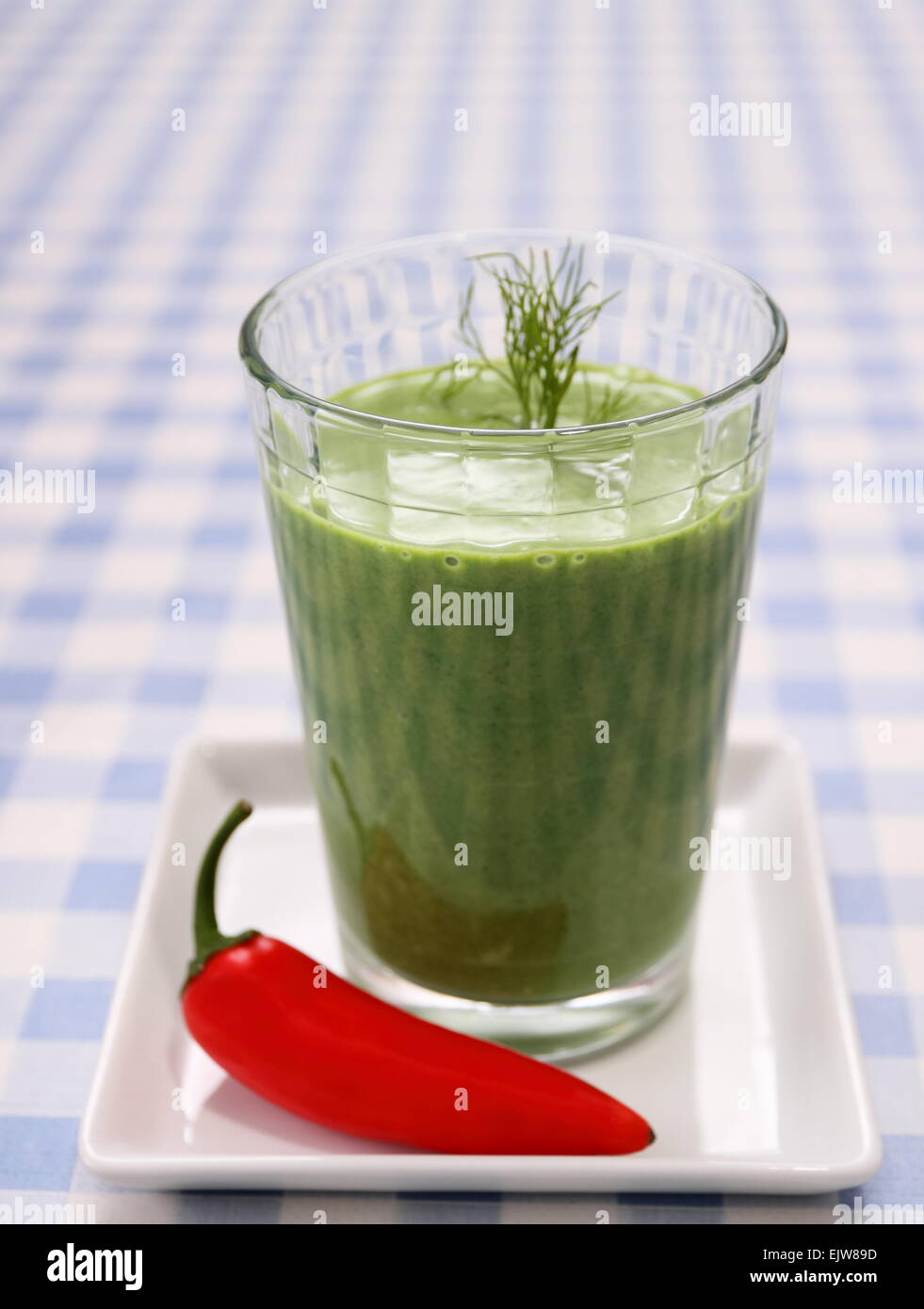 Green spinach smoothie with sweet red peppers, close up Stock Photo