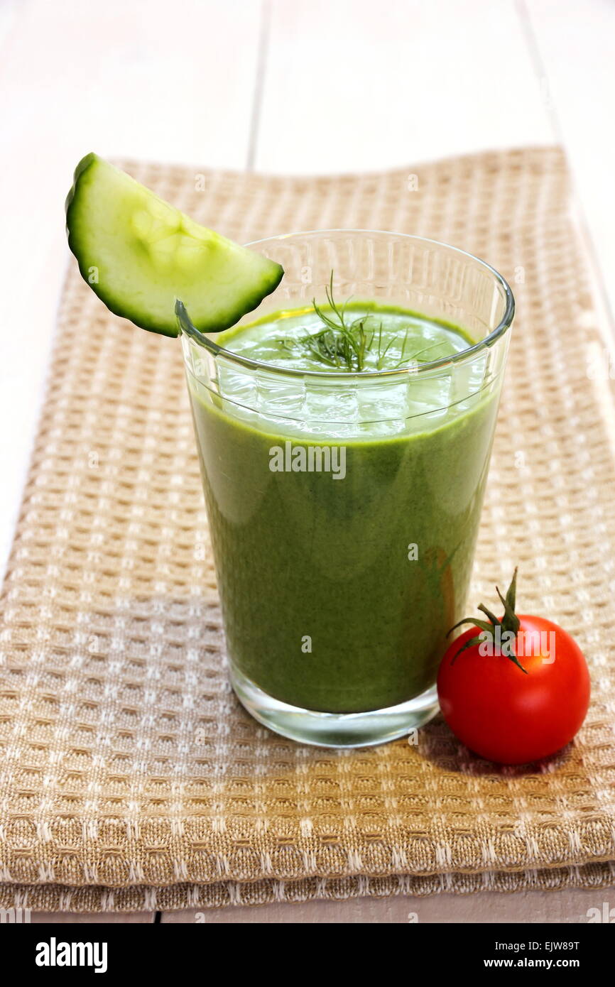 Green smoothie spinach, cucumber and small red tomato, close up Stock