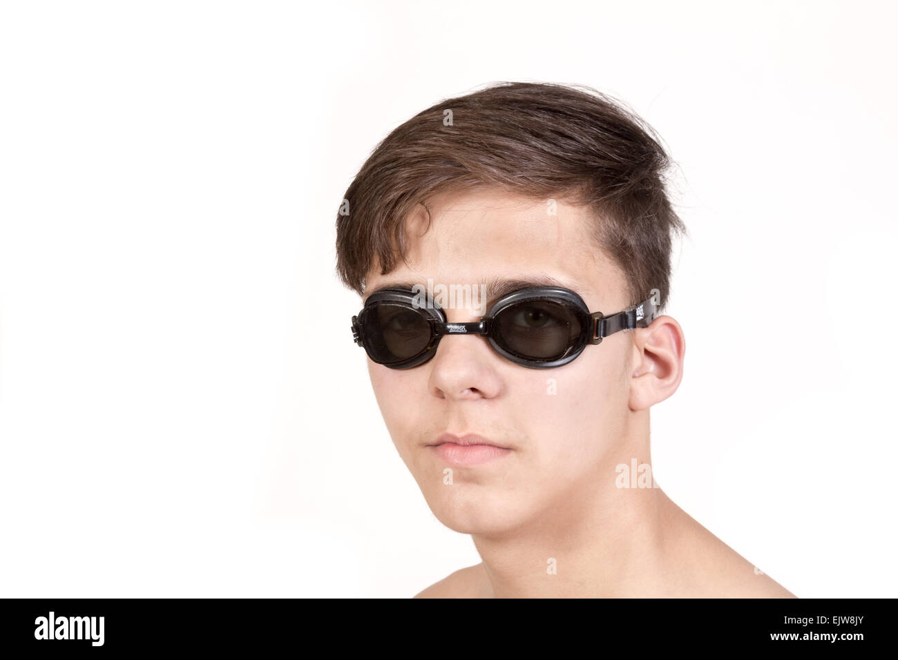 White teenage boy wearing swimming goggles. Stock Photo