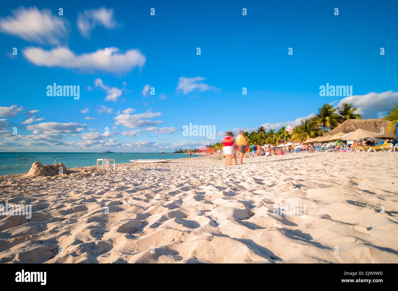 Isla Mujeres, Mexico - April 21, 2014: long exposure of tourists enjoying sunset on famous Playa del Norte beach in Isla Mujeres Stock Photo