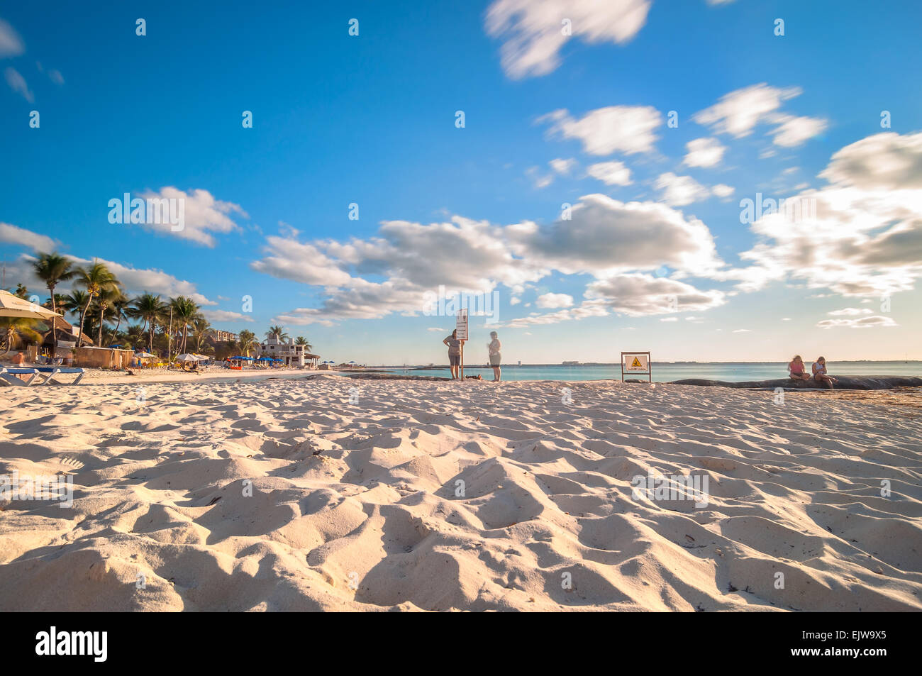 Isla Mujeres, Mexico - April 21, 2014: long exposure of tourists enjoying sunset on famous Playa del Norte beach in Isla Mujeres Stock Photo