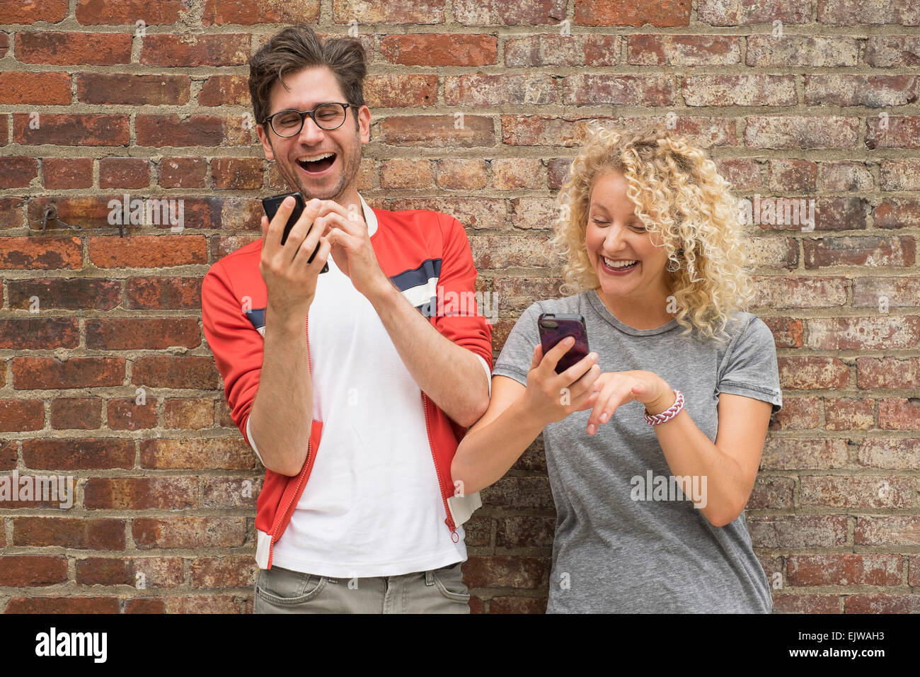 Couple using cell phones Stock Photo