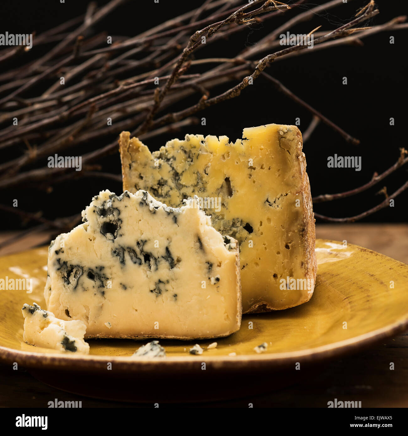 Blue cheese slices on plate, studio shot Stock Photo