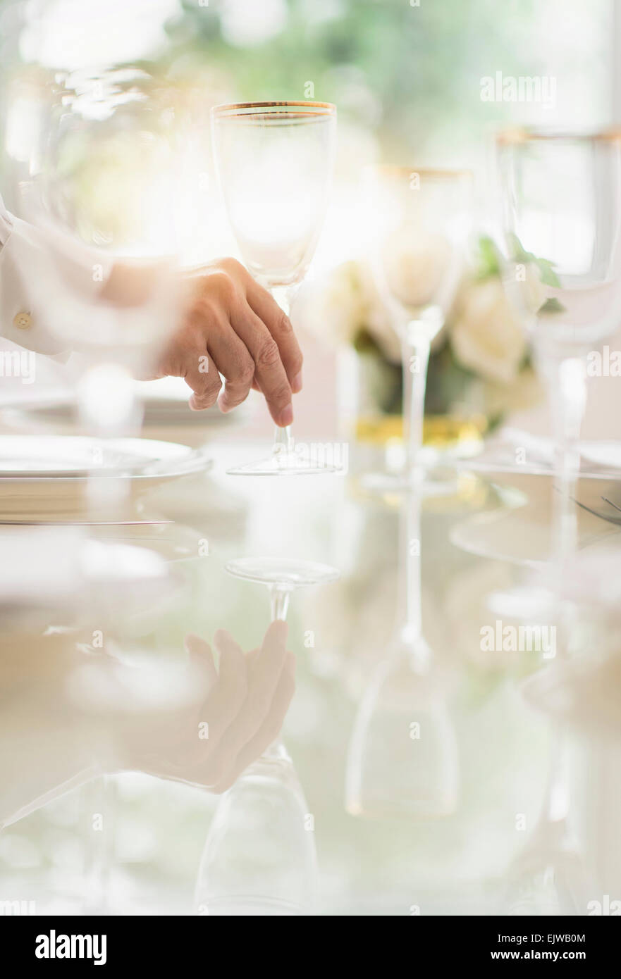Close up of man's hand setting place in restaurant Stock Photo