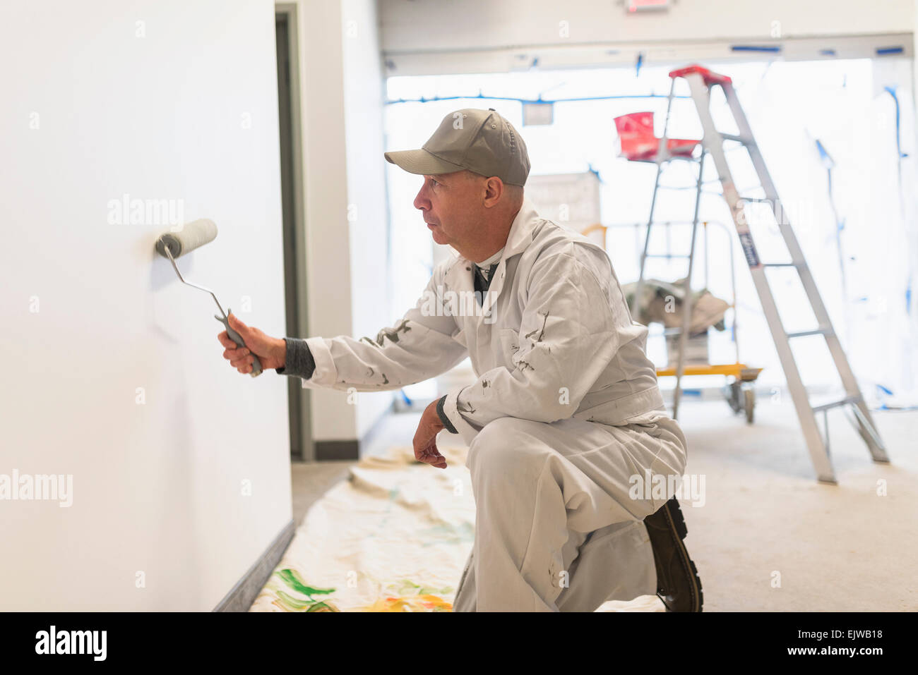 Manual worker painting wall Stock Photo Alamy